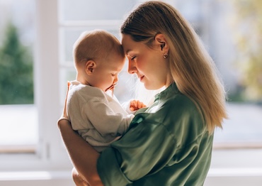 The profound connection between a loving mother and her baby, a serene snapshot of the beauty and tenderness of motherhood.